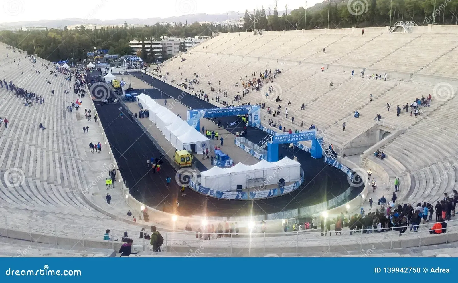 Starten av ett maratonlopp i en stadion. Många åskådare.